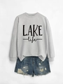 Close-up of gray LAKE life sweatshirt paired with distressed blue denim shorts - Grey Sweatshirt (Black Print)