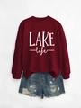 Detail view of burgundy LAKE life sweatshirt paired with distressed denim shorts on a plain background - Wine Red Sweatshirt (White Print)