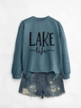 Detailed flat lay of long sleeve blue-grey sweatshirt featuring LAKE life lettering - Blue Sweatshirt (Black Print)