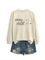 Detail of Vacay Mode heart print on beige sweatshirt paired with denim shorts - Sand (Black Letters)