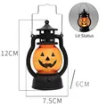 Halloween pumpkin LED lantern in black with orange smiling face and light-on effect - 7.5cm / Fang Style