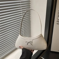Minimalist beige half-moon underarm bag with a metal bow clasp and smooth PU leather - White