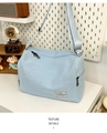 Detail of light blue fabric crossbody bag with black zipper and adjustable strap - Blue