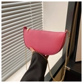 Detail of pink crescent bag with litchi texture leather and golden chain strap - Pink