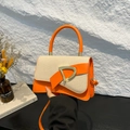 Chic orange leather and woven fabric shoulder bag with a gold D-buckle closure - Orange