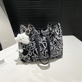 Canvas bucket tote bag with graffiti prints, leather chain strap, and plush charm - With Pendant / Black