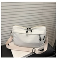 Detail of white nylon crossbody bag with zipper pocket and adjustable strap - White