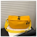 Detail view of a bright yellow waterproof crossbody bag with dual zippers and wide strap - Yellow