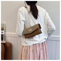 Detailed back view of a woman wearing a vintage brown patchwork box bag with a gold chain strap - Brown