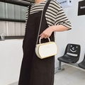 White box crossbody bag with gold hardware and chain strap shown on model outdoors - Off-white