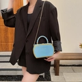 Light blue hexagonal box bag with gold metal trim and chain strap shown on model - Blue
