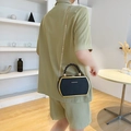 Elegant black hexagonal crossbody bag with gold frame and woven handle for women - Black