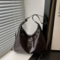Minimalist dark brown hobo shoulder bag in retro matte PU leather on a modern windowsill - Brown