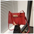 Detail of red crocodile pattern PU leather handbag featuring golden metal buckle hardware - Red