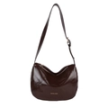Deep brown glossy leather crescent shoulder bag with adjustable strap and gold lettering - Brown
