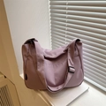 Purple waterproof nylon shoulder bag with adjustable strap and front pockets in soft light - Purple