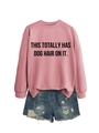 Close-up of pink long-sleeved sweatshirt with black text and distressed blue denim shorts - Rose Gold (Black Font)
