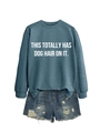 Close-up of grey-blue sweatshirt with white slogan and distressed denim shorts - Blue (White Font)