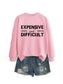 Detail of pink crewneck sweatshirt with 'EXPENSIVE and DIFFICULT' text and denim shorts - Pink (Black Print)