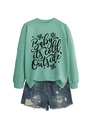 Close-up of mint green sweatshirt with snowflake print and distressed denim shorts - Light Green (Black Text)