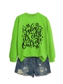 Flat lay of neon green sweatshirt with snowflake print and distressed denim shorts - Neon Green (Black Font)