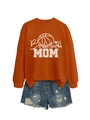 Flat lay of an orange Basketball MOM sweatshirt styled with distressed denim shorts - Burnt Orange (White Print)