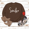 Detailed flat lay of brown sweatshirt with smile print and red heart patch on cuff - Coffee (White Font)