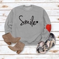 Detail of grey crewneck sweatshirt with red heart patch on sleeve and Smile print - Grey (Black Font)