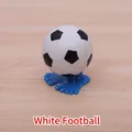 Wind-up soccer ball toy with blue feet base on wood surface for kids gift - Football