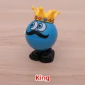 Wind-up King toy featuring a blue spherical body with a yellow crown and big eyes - King