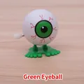 Wind-up jumping toy featuring a white eyeball with green pupils and large green feet - Green Eyeball