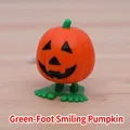 Wind-up Halloween pumpkin toy with orange smiley face and green walking feet - Pumpkin With Green Feet