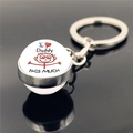 Detail view of double-sided glass crystal keychain with I Love Daddy print on black surface - I Love Daddy This Much Style (XSWX2255-1)