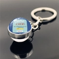 Macro shot of silver keychain with blue crystal dome and papa CHÉRI French inscription - papa CHERI Style (XSWX2255-2)