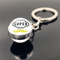 Macro shot of silver keychain with Super Papa text and mustache pattern on black surface - Super Papa Mustache Design (XSWX2255-8)