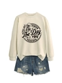 Flat lay of beige sweatshirt with skull graphic and distressed blue denim shorts set - S / Sand (Black Print)