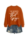 Detail view of orange graphic sweatshirt with OH HONEY text and distressed denim shorts - Burnt Orange (White Font)