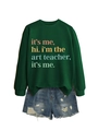 Flat lay of a green 'I'm the art teacher' sweatshirt paired with distressed denim shorts - Dark Green