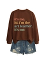 Detail of loose brown crewneck sweatshirt with art print and ripped denim shorts - Coffee
