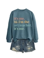 Flat lay of blue crewneck sweatshirt with art teacher slogan and denim shorts - Blue