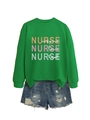 Flat lay of green nurse sweatshirt with inspire love heal text and denim shorts - Grass Green
