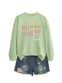 Detail of sage green nurse sweatshirt featuring inspire love heal text and denim shorts - Olive Green