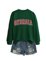 Detail of Georgia letter print on green sweatshirt paired with blue ripped denim shorts - Dark Green