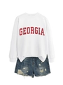 Flat lay of white Georgia letter sweatshirt with distressed denim shorts for casual wear - White
