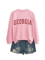 Pink sweatshirt with GEORGIA lettering paired with distressed denim shorts on white background - Pink