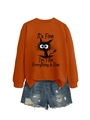 Detail of orange sweatshirt with It's Fine black cat print and ripped denim shorts - Burnt Orange (Black Print)