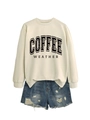 Detail of coffee weather sweatshirt in beige cotton paired with distressed denim shorts - Sand Sweatshirt (Black Text)