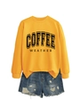Detail view of ginger yellow coffee weather sweatshirt with blue distressed denim shorts - Yellow Sweatshirt (Black Text)