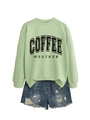 Close-up of COFFEE WEATHER print and distressed denim shorts with ripped details - Olive Green Sweatshirt (Black Text)