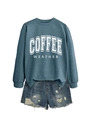 Detail view of coffee weather print sweatshirt paired with distressed denim shorts - Blue Sweatshirt (White Text)
